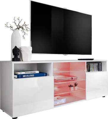 A modern white TV stand with a large black TV on top, decorated with a vase and a Buddha statue.
