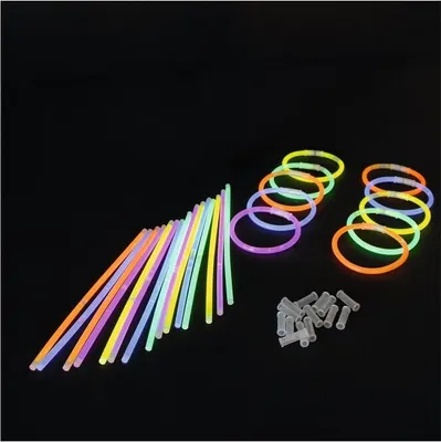 A collection of glow sticks and bracelets on a black background.