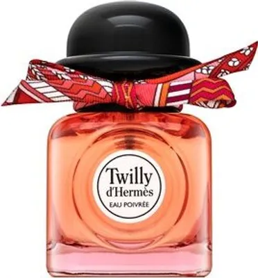 A perfume bottle with a black cap and a patterned scarf tied around the neck.