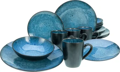 A collection of blue and black ceramic dinnerware, including plates, bowls, and mugs, arranged on a white background.