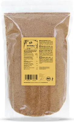 A clear plastic bag filled with brown granular product, with a yellow label on the front.