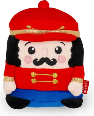 A plush toy nutcracker against a white background.