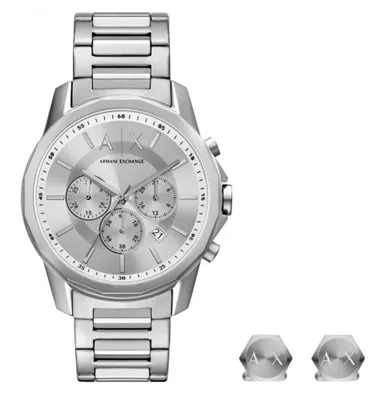 A silver Armani Exchange Banks Chronograph SET AX7141SET watch is displayed on a white background, with two small hexagonal accessories also visible.