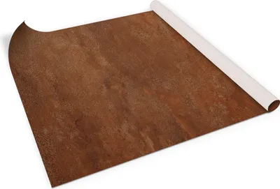 A rolled-up sheet of textured material with a rust-like pattern, lying on a white surface.