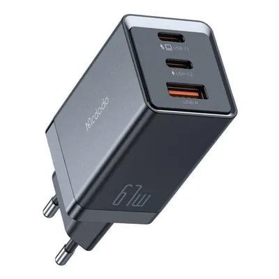 A close-up, angled shot of a black GaN wall charger with multiple ports.