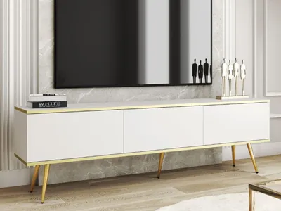 A white TV stand with gold accents and metal legs, placed in a modern living room setting.