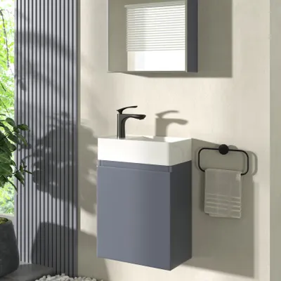 A modern bathroom vanity with a sink and faucet, set against a textured wall and a window with vertical blinds.