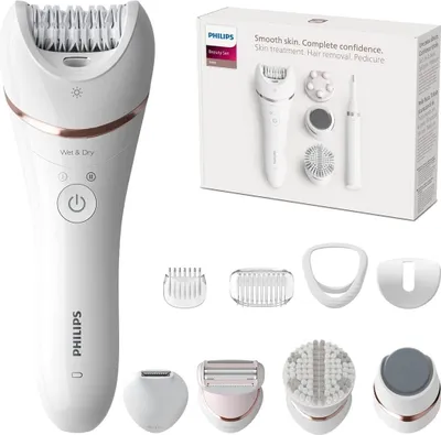 A Philips hair removal and beauty set is displayed with its accessories and packaging.