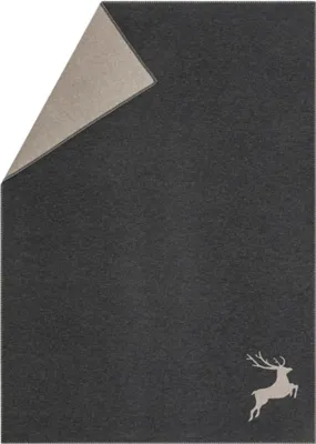 A folded blanket with a deer motif.