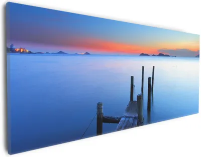 Produktbild von Wallario Premium Leinwandbild Steg im Wasser - Abendstimmung am Meer in Größe 30 x 75 cm