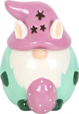 A ceramic gnome figurine with bunny ears, holding an Easter egg.