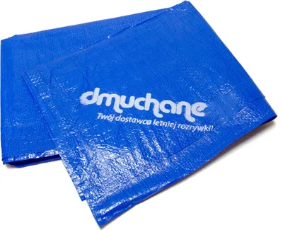 A blue tarp with white text is folded and lying on a white surface.