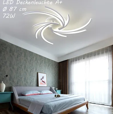 A bedroom with a bed, nightstands, and a ceiling light.