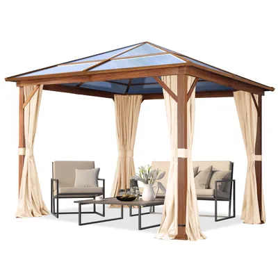 A wooden gazebo with a blue polycarbonate roof and beige curtains, set up with outdoor furniture.