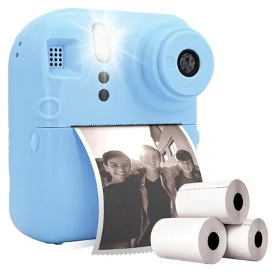 A light blue instant camera is shown printing a photo of three smiling teenagers. Three rolls of thermal paper are next to the camera.