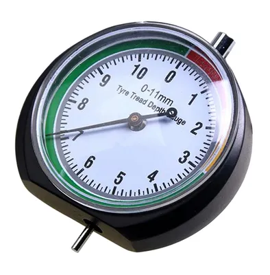 A close-up of a tire tread depth gauge on a white background.
