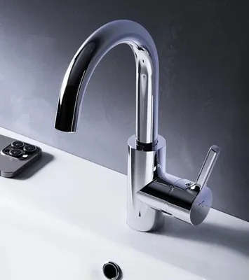 A chrome faucet is shown in a bathroom sink.
