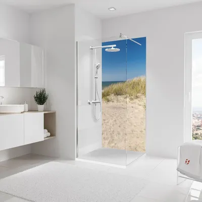 A modern bathroom with a shower featuring a scenic beach mural.