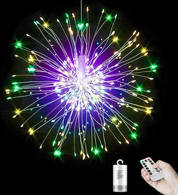 A starburst-shaped string of lights with multiple colors, including purple, green, and yellow, against a black background. A remote control and a battery pack are shown in the bottom right corner.