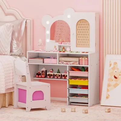 A child's vanity table and chair set in a pink-themed room.
