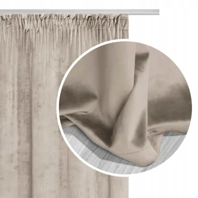 A close-up view of a beige velour curtain, showing its texture and folds.