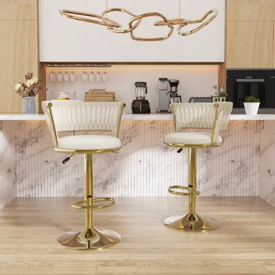 Two white and gold bar stools are shown in a modern kitchen setting.