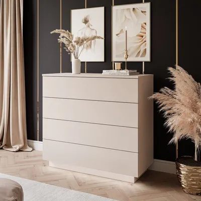 A modern bedroom scene featuring a beige dresser with artwork and decor on top.