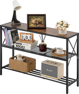 A three-tier console table with various decorative items and books placed on it.