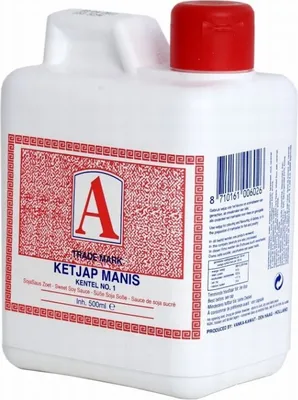 A white plastic bottle of Ketjap Manis (sweet soy sauce) with a red cap, featuring a red and white label with product information and a barcode.