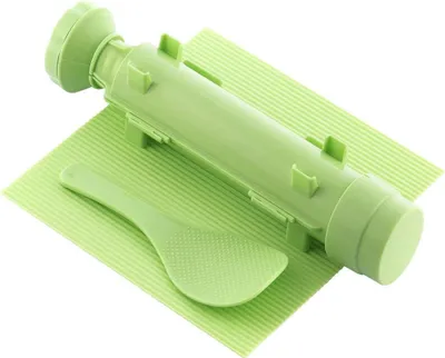 A light green sushi-making set is displayed on a light green mat.