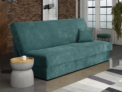 A teal corduroy sofa bed is shown in a living room setting with a small side table and a rug.