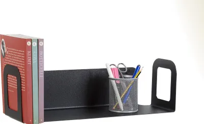 A black metal shelf with two books and a pen holder with pens and scissors.
