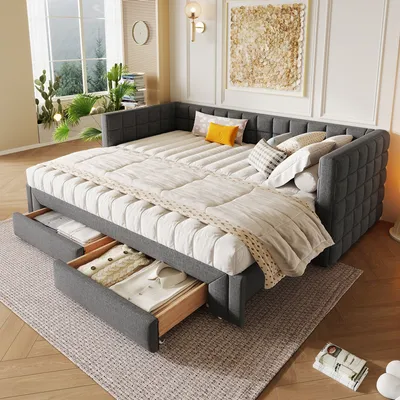 A daybed in a well-lit room with plants and artwork.