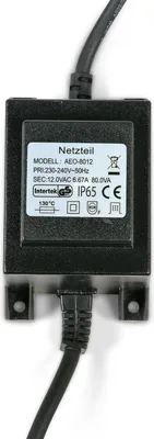 A black electrical transformer with a label showing technical specifications and safety certifications.
