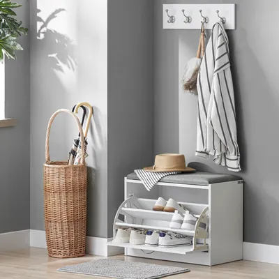 An entryway with a shoe bench, umbrella stand, and coat rack.