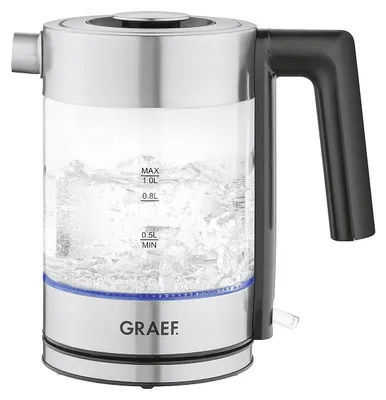 A glass electric kettle with water boiling inside, sitting on a white background.