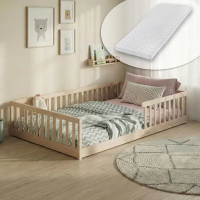 A child's bed with bedding in a room setting.