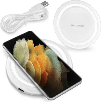 A smartphone is placed on a wireless charging pad, with a USB cable nearby. The charging pad has text indicating it is a fast charger.