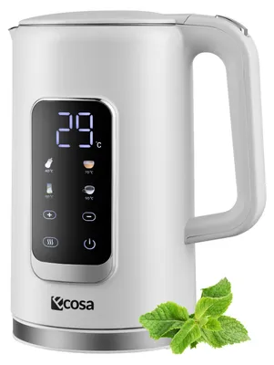 A white electric kettle with a digital display and a sprig of mint in the foreground.