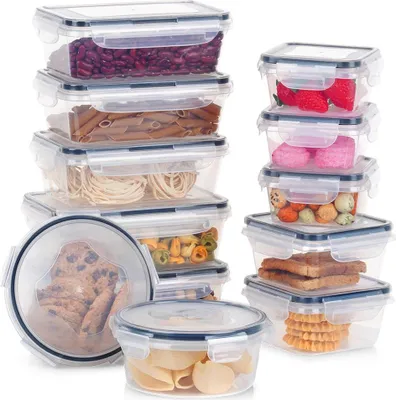 A collection of clear plastic food storage containers filled with various food items, neatly stacked and arranged against a white background.