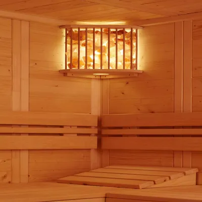 Interior of a wooden sauna with a salt crystal lamp.