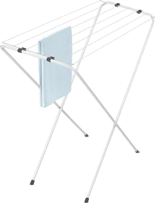 A small, foldable clothes drying rack with a light blue towel draped over one of the bars, set against a white background.