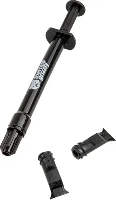 A black syringe of thermal paste with two detached caps.