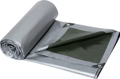 A rolled-up silver tarp with a green underside, partially unrolled to show its construction and grommets.