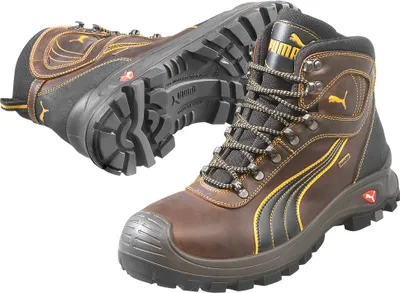 Two brown Puma work boots are shown against a white background. One boot is upright and facing forward, while the other is lying on its side, showing its sole.