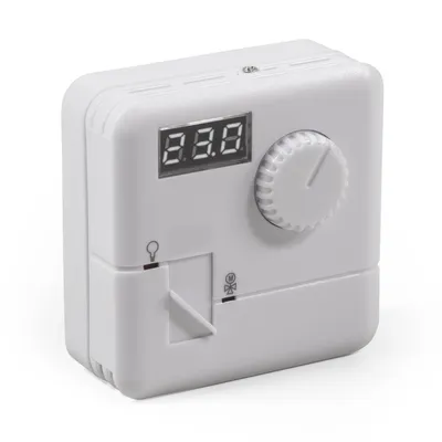 A white thermostat with a digital display and a rotary dial.