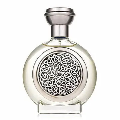 A clear, professional studio shot of a round perfume bottle with a silver cap and a decorative silver Celtic knot design on the front.