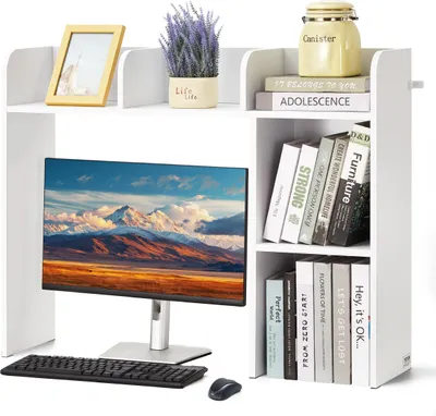 A white desk organizer with a computer monitor, keyboard, mouse, books, and decorative items.