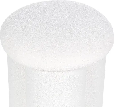 A close-up view of a white, textured pouf.
