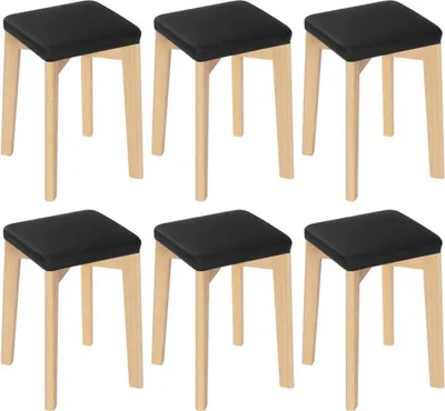 Six black stools with wooden legs arranged in two rows.